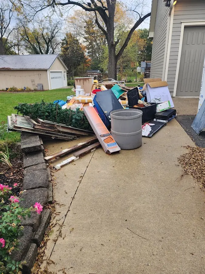 Dumpster being loaded with debris for 12 Yard Dumpster Rental in Pine Grove